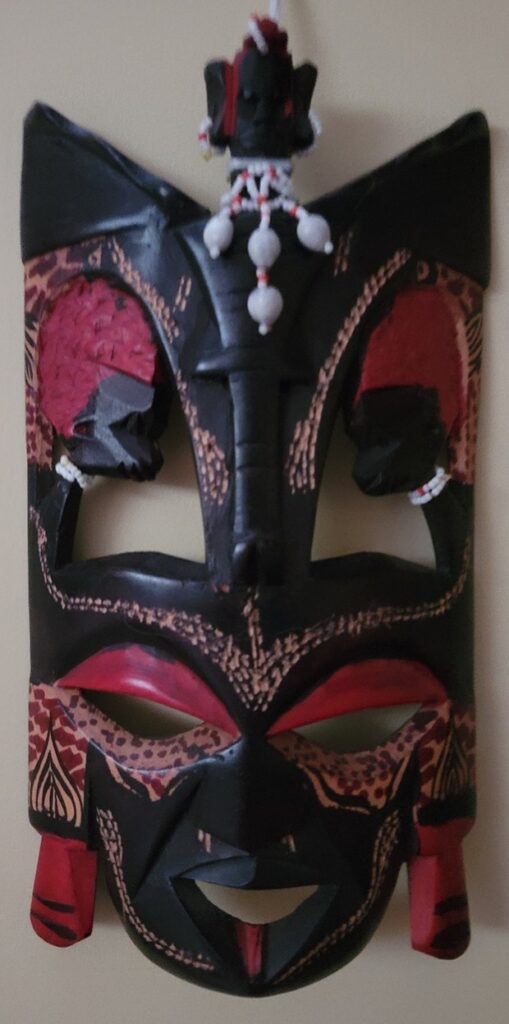 Ugandan mask carved from wood similar to South African mask