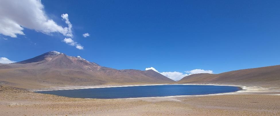 Laguna Miscanti in the Atacama Desert, a deep blue high‑altitude lake surrounded by mountains