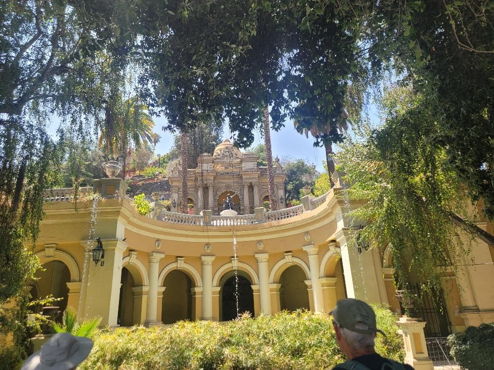 Terraza Neptuno in Santiago, Chile, featuring yellow arches, fountains, and lush greenery.