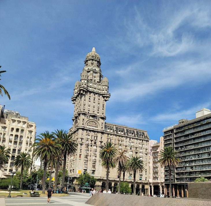 Palacio Salvo in Montevideo, Uruguay, with palm trees lining Plaza Independencia