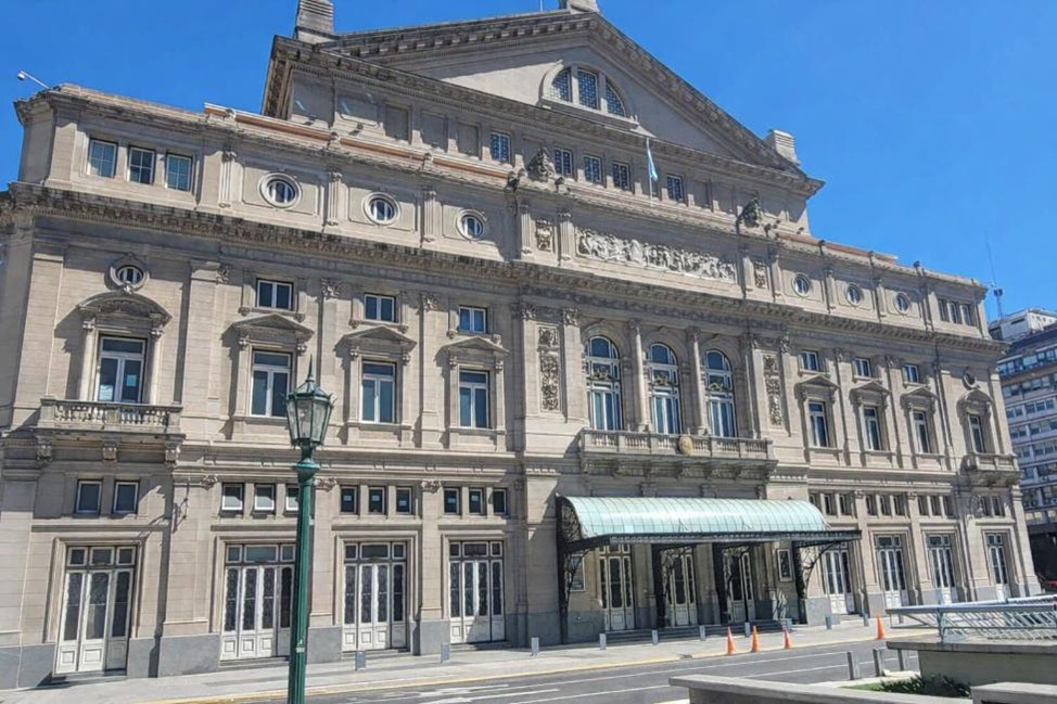 Historic Teatro Colón opera house in Buenos Aires with columns, arches, and detailed façade
