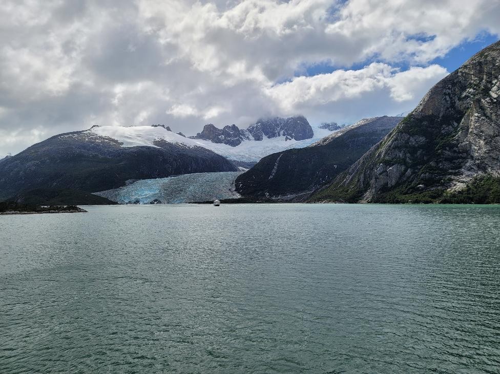 - Pía Glacier in Tierra del Fuego, Chile, descending between steep mountains into a fjord with a small boat below.”
- “View of the Pía Glacier flowing into a fjord in Tierra del Fuego, with a boat near the glacier face.